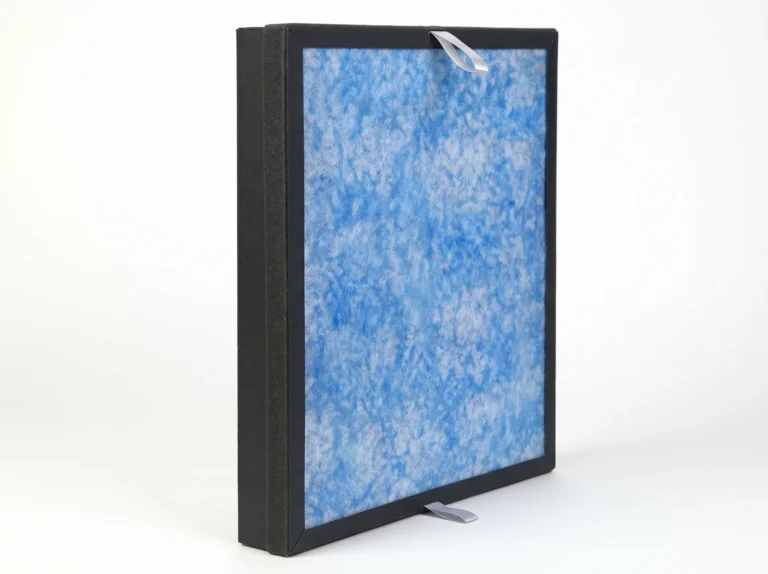 Close-up of a blue air purifier filter panel encased in a black frame with white pull tabs, used for air cleaning systems.